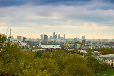 View of cityscape against cloudy sky