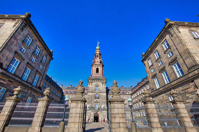 Low angle view of buildings against blue sky