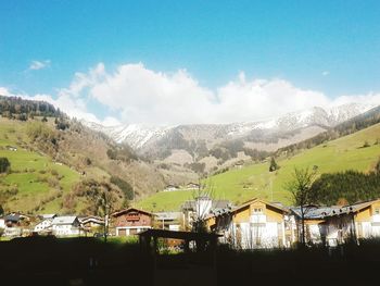 Houses on mountain against sky