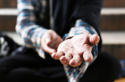 Midsection of homeless man gesturing