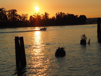 Scenic view of lake against sky during sunset