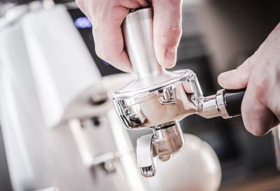 Midsection of man holding coffee cup