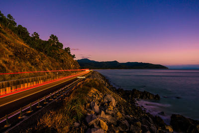 Panoramic view of road by sea against clear sky