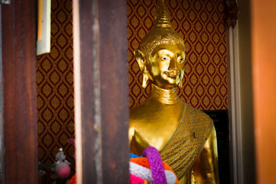 Statue of buddha against building