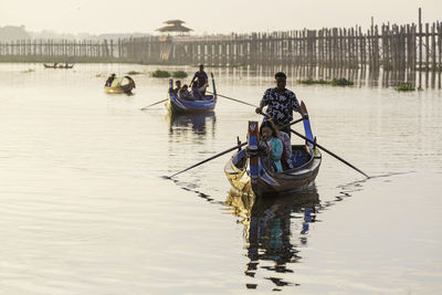 Rear view of people on boat in river