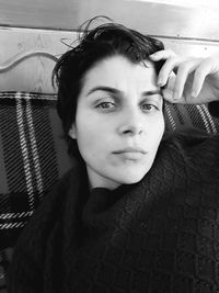 Close-up portrait of young woman at home