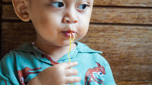 Close-up of boy eating noodles