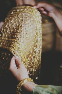 Close-up of woman holding wedding dress