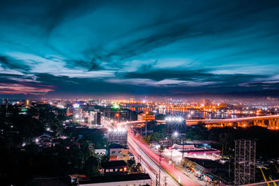 Illuminated cityscape against sky at night