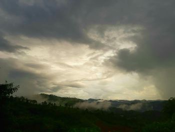 Scenic view of landscape against dramatic sky