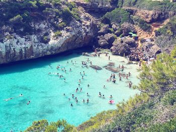 High angle view of people swimming in sea