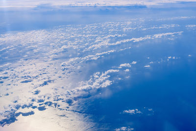 Aerial view of sea against blue sky