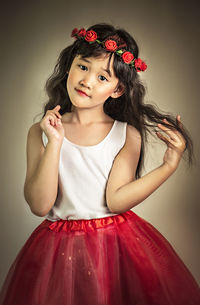 Portrait of a beautiful young woman against gray background