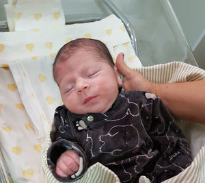 High angle view of baby girl lying on bed at home