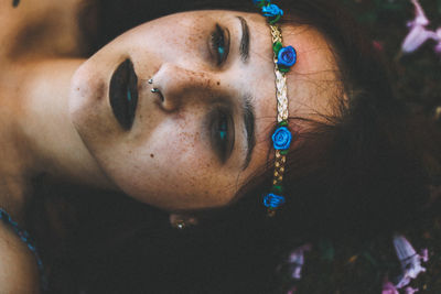 Side view of woman lying on field