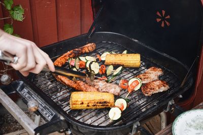 Man preparing food on barbecue grill