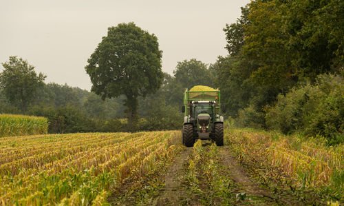 Agricultural machinery tractor and chopper during the corn harvest