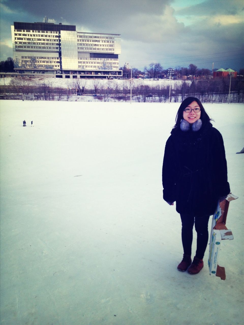 winter, snow, cold temperature, building exterior, architecture, lifestyles, built structure, warm clothing, young adult, leisure activity, season, person, casual clothing, full length, weather, standing, portrait, looking at camera