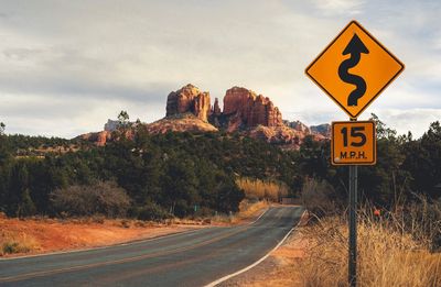 Road sign against sky