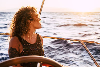 Woman looking at sea seen through boat