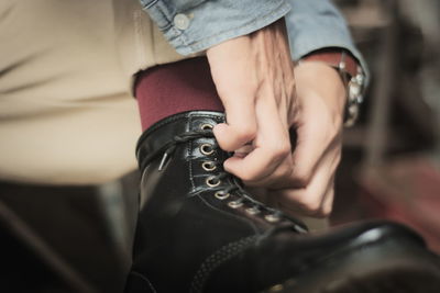 Low section of woman wearing shoe