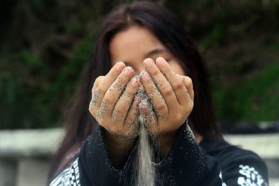 Young woman pouring sand