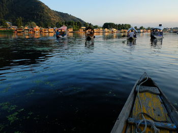 People in lake against sky