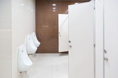 Men's toilet room, white plumbing.