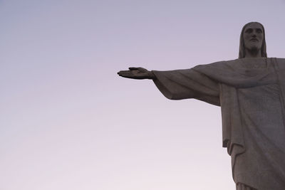 Low angle view of man standing against clear sky