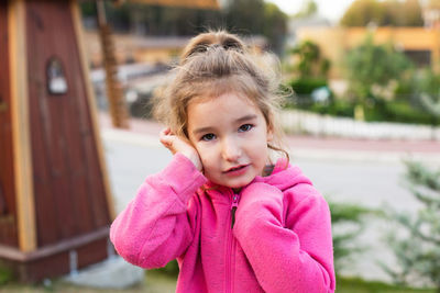 Portrait of cute girl standing outdoors