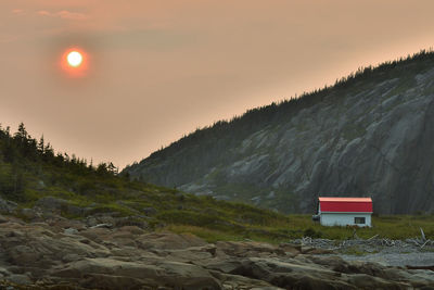 Scenic view of land against sky during sunset