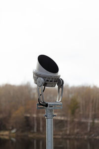 Modern headlight seen from the side with trees in the background