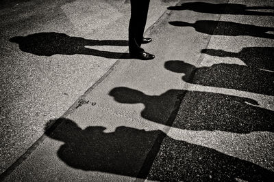 Low section of man standing on tiled floor