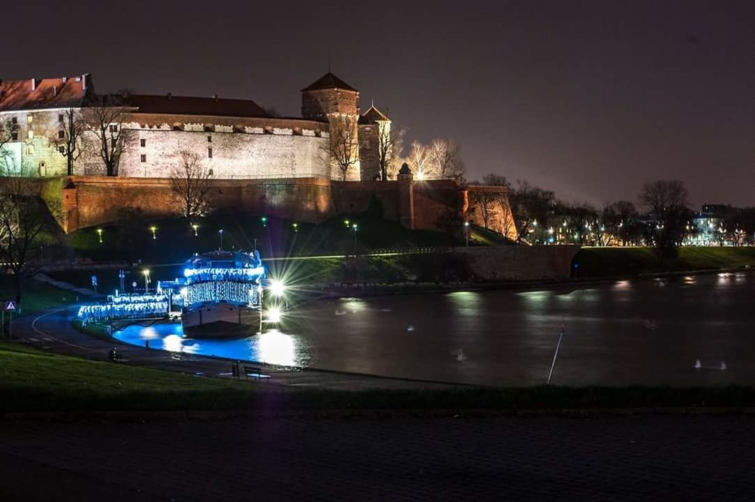 ILLUMINATED CITY AT WATERFRONT