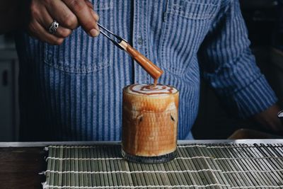 Man holding coffee cup on table