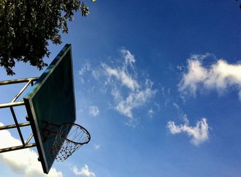 Low angle view of basketball hoop against blue sky