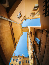 Low angle view of residential buildings against blue sky