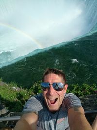 Portrait of smiling man against mountains