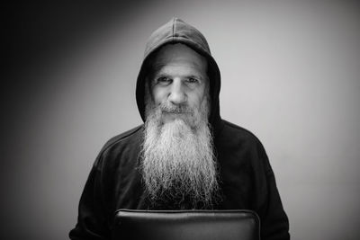 Portrait of man wearing hat against gray background