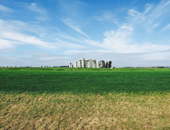 Old ruins on field against sky