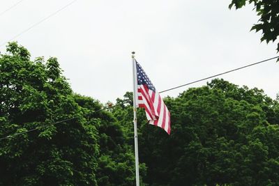 Low angle view of american flag against sky