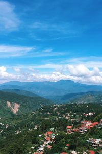 High angle view of town against blue sky