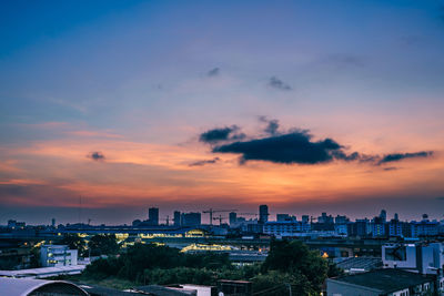 High angle view of buildings against cloudy sky during sunset