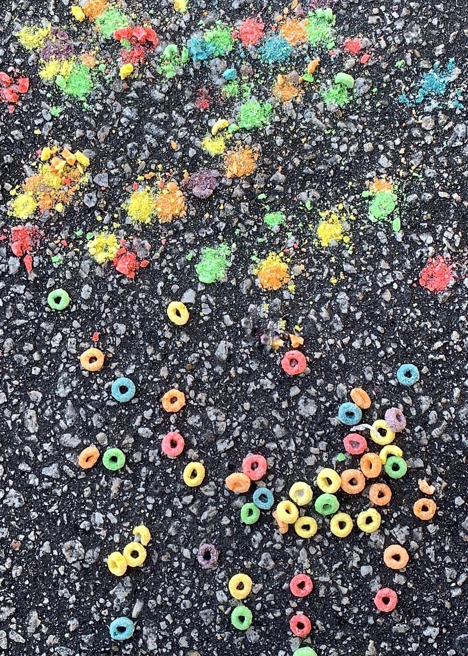 HIGH ANGLE VIEW OF MULTI COLORED PENCILS ON STREET