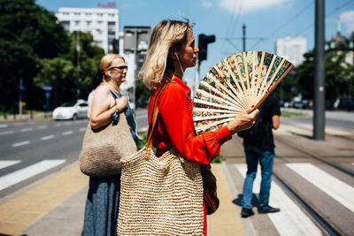 Woman with umbrella walking on street