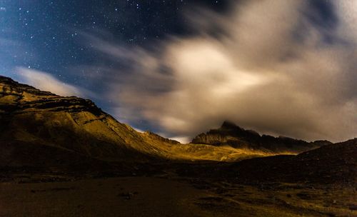 Scenic view of mountains against sky at night