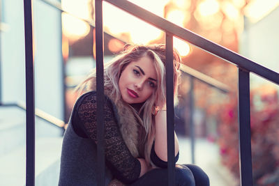 Portrait of beautiful woman at railing during winter