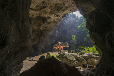 Panoramic view of temple and buildings seen through cave