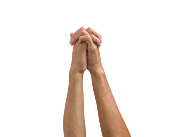 Close-up of hand praying against white background