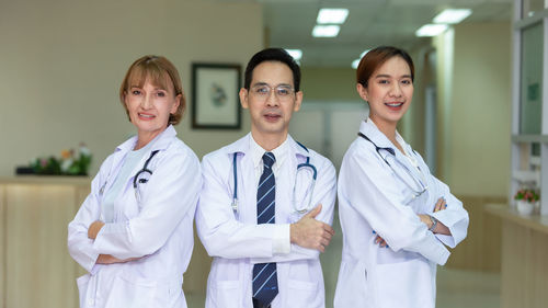 Portrait of smiling young woman standing in hospital